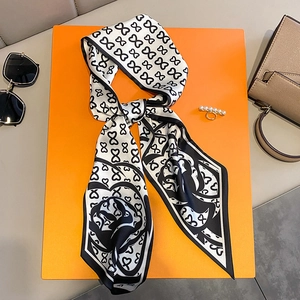 Polka dot silk scarf and pearl ring set with floral patterns on orange background