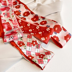 Vue détaillée de foulards en soie imprimés rouge et rose avec motifs fleurs et cœurs