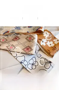 Close-up of silk neck scarves showing various geometric patterns and soft fabric textures