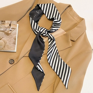 Narrow black and white striped satin twilly scarf with elegant script on blazer