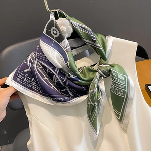 Elegant silk square scarf featuring green and purple geometric patterns and Paris motifs