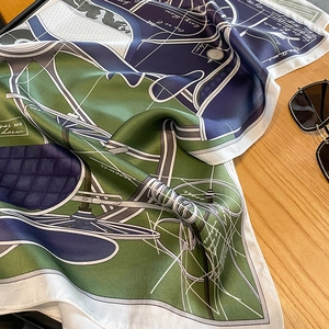 Detail of silk square scarf featuring olive green geometric patterns and vintage carriage design