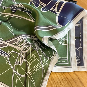 Macro detail of high-quality silk square scarf with horse pattern and polished finish