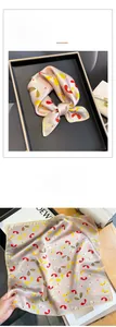 Detailed view of silk square scarf featuring vintage abstract butterfly patterns and prints