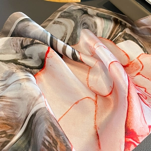 Silk square scarf featuring brown marble print and vibrant orange flowing art lines