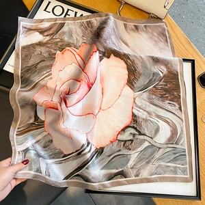 Elegant silk square scarf featuring a large orange rose print and abstract grey texture