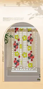 Detail of embroidered lace cafe curtain with ladybug patterns and tassel fringe