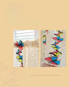 Detail of colorful butterfly embroidery and tassel fringe on beige lace cafe curtain