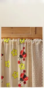 Detail of floral embroidery with red ladybugs on beige lace cafe window curtain