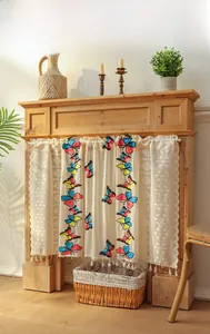 Detailed embroidery of colorful butterflies on beige lace cafe curtain with tassel trim