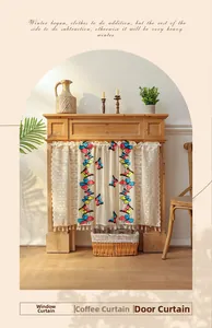 Detail of colorful butterfly embroidery and fringe trim on a cream lace cafe curtain