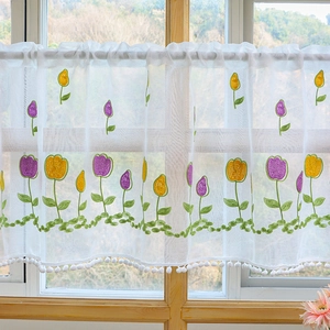White sheer cafe curtain with tulip embroidery and pom-pom trim for kitchen windows