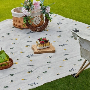 Floral cotton picnic mat with lavender print on grass for outdoor camping and beach