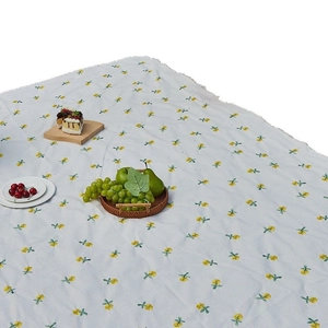 Waterproof picnic mat with yellow floral pattern and fringe edges for outdoor camping use