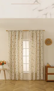 Détail de rideaux en lin avec broderie d'épis et bordure à franges blanche