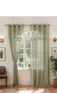 Detail of green floral lace curtain with translucent fabric and metal eyelet top