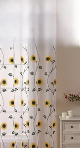 Detailed embroidery of yellow sunflowers on white sheer curtains in farmhouse style