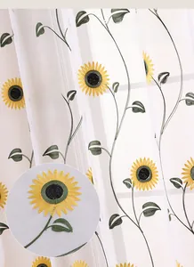 Detail of embroidered sunflower patterns on semi-transparent white tulle curtains