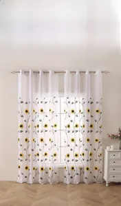 Detailed embroidery of yellow sunflowers on white semi-transparent sheer curtains