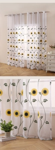 Detailed embroidery of yellow sunflowers on semi-transparent white sheer curtains