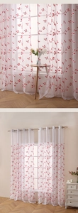 Close-up of red botanical vine embroidery on translucent white tulle window curtain