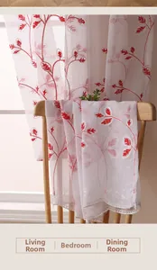 Detail of white semi-sheer curtain with red leaf embroidery and elegant scalloped edge