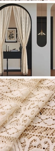 Detailed macro view of cream lace door curtain with geometric pattern and mini tassels