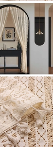 Detailed view of cream lace curtain with intricate crochet texture and fringe tassels