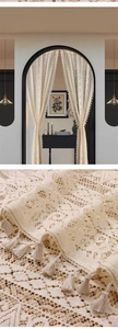 Detailed close-up of French vintage cream lace curtain with hollow crochet and elegant tassels