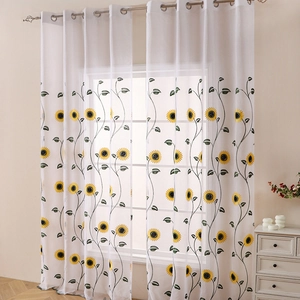 White semi-sheer curtain featuring embroidered yellow sunflowers and silver metal grommets