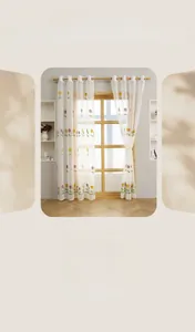 Close-up of elegant tulip embroidery on white sheer curtains with metal grommet top