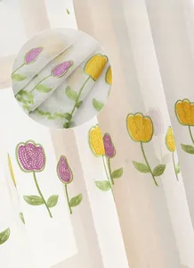 Detail of embroidered tulip pattern on semi-transparent white polyester sheer curtain