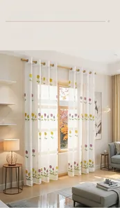 Detailed view of yellow and purple tulip embroidery on semi-transparent white sheer curtain
