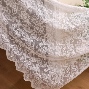 Elegant white lace curtain featuring floral swirls and scalloped edges with pearl details