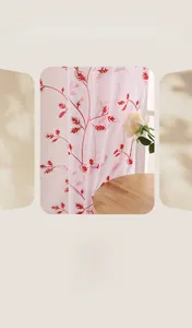 Detailed embroidery of red leaf patterns on white semi-sheer country style window curtain