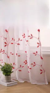 Detail of red floral embroidery on white sheer curtains for living room decor