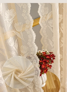 Macro detail of tulip lace embroidery on beige sheer curtains for windows