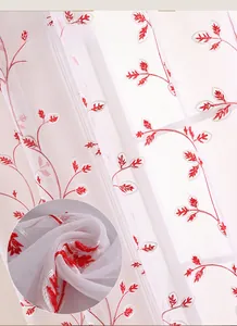Close-up of white sheer curtain with detailed red silk embroidered leaf patterns