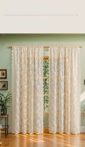 Detail of cream lace sheer curtain featuring elegant tulip embroidery and wavy edges