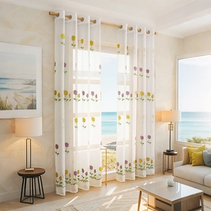 Modern white sheer curtains with tulip embroidery in a scenic living room with sea view