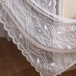White lace door curtain with elegant branch and bird embroidery and wavy scalloped edges