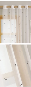 Close-up of cute cat embroidery on white semi-sheer grommet curtains for kids' rooms