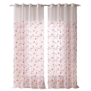 White sheer curtains with red floral embroidery and silver metal grommets at the top