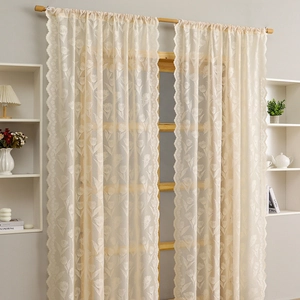 Cream lace curtains with tulip embroidery and scalloped edges for a warm home decor