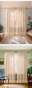 Detail of vintage floral lace sheer curtain with delicate cream crochet pattern finish