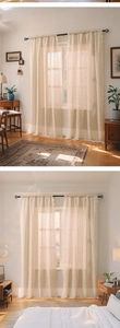 Detail of floral lace semi-sheer curtain with scalloped edges and warm natural lighting