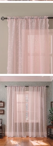 Detail of pink floral lace curtain featuring delicate embroidery and scalloped wavy edges