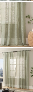 Detail of sage green floral lace curtain featuring scalloped edges and delicate embroidery