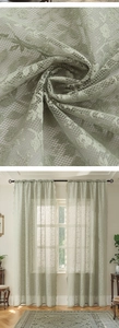 Detailed close-up of light green lace sheer curtain with delicate floral patterns