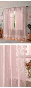 Detail of pink floral embroidery and scalloped lace edge on French style sheer curtain